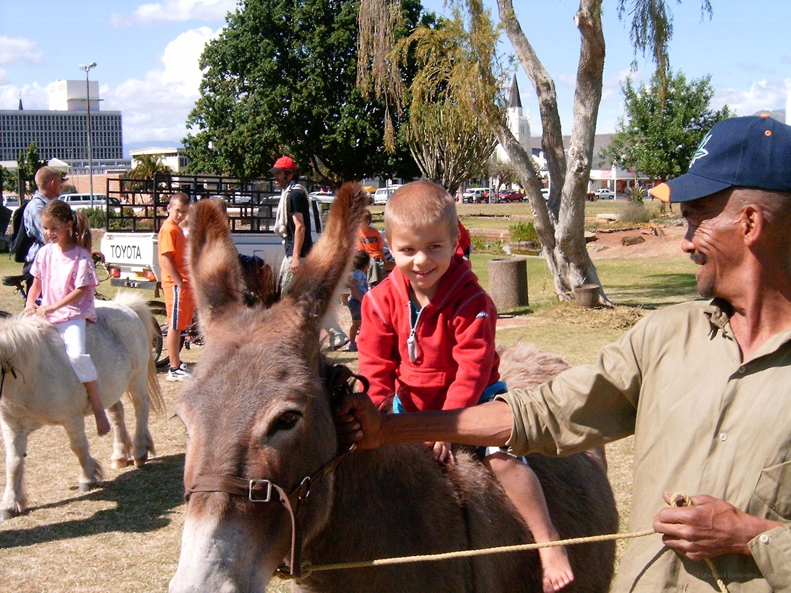 Children riding donkeys at fair