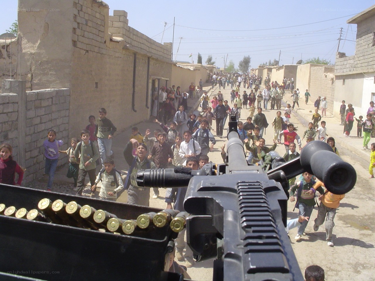 Children running near machine gun
