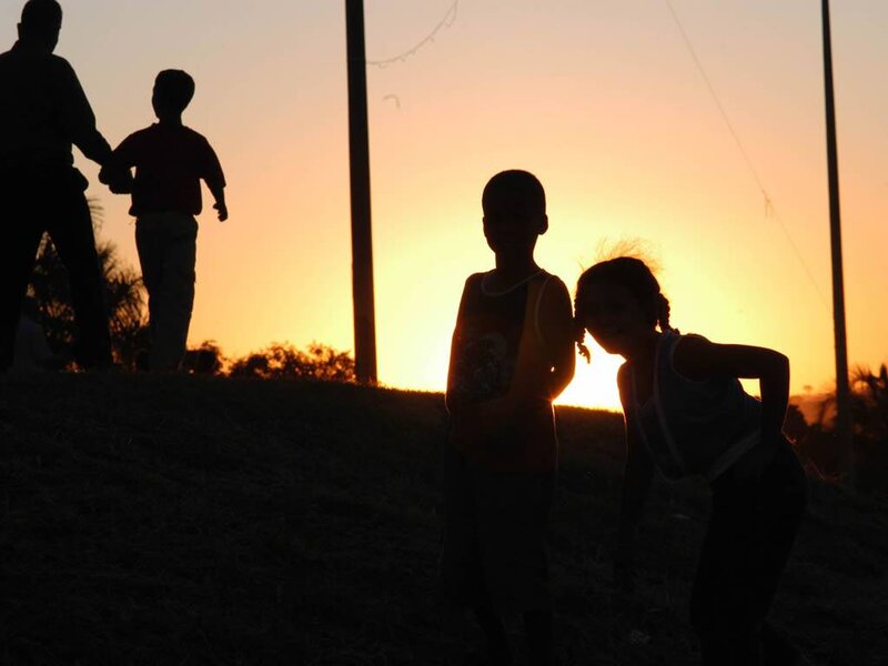 Children Silhouetted at Sunset — Orange