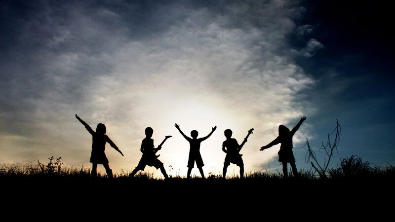 Children Silhouetted on Hill