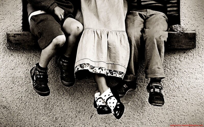 children sitting on a ledge