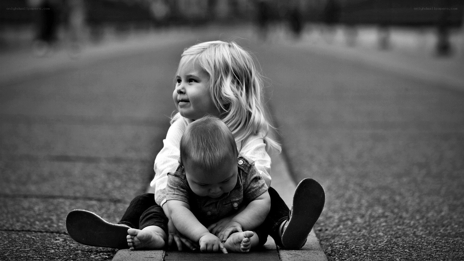 Children sitting on pavement