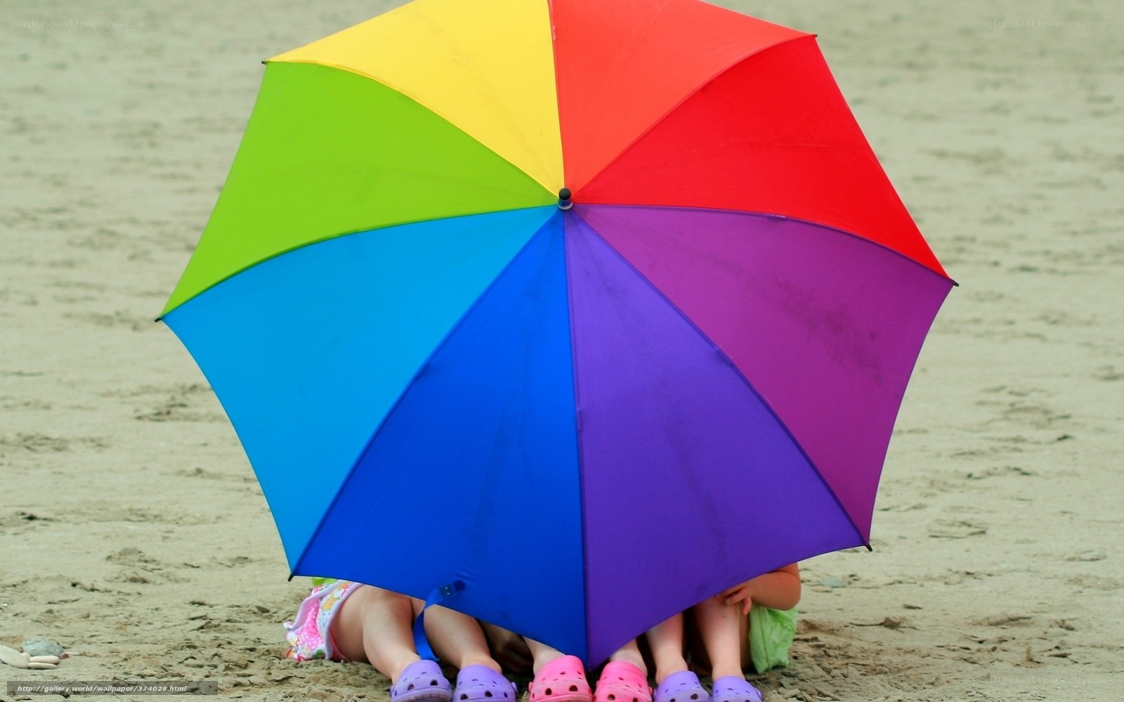 Children under rainbow umbrella