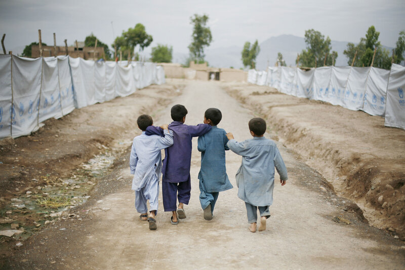 Children walking in a refugee camp