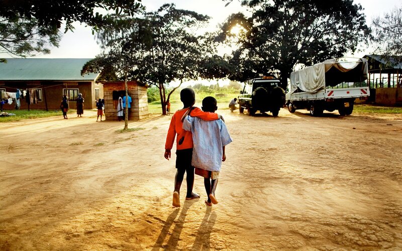 Children walking on a dirt path