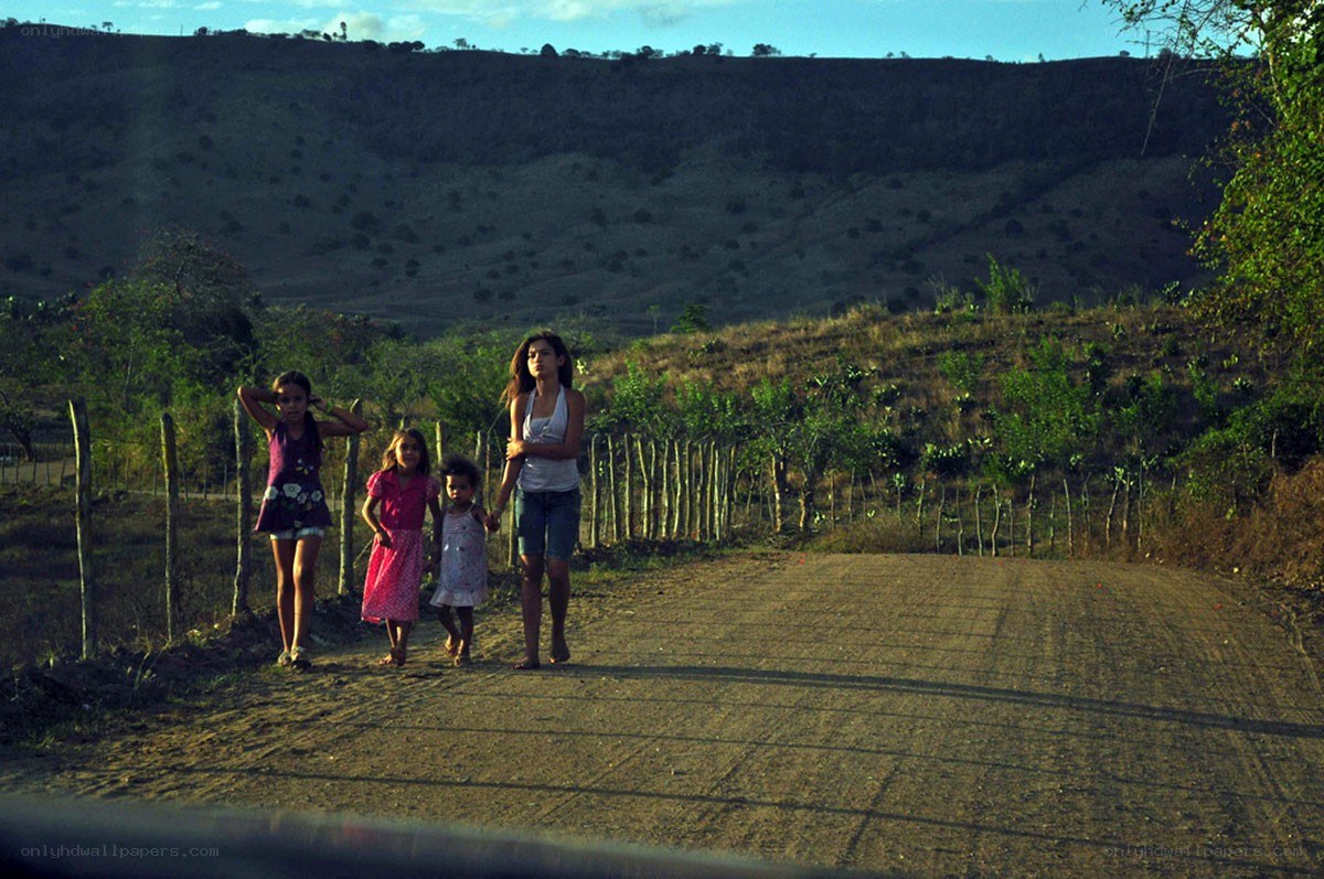 Children walking on a dirt road
