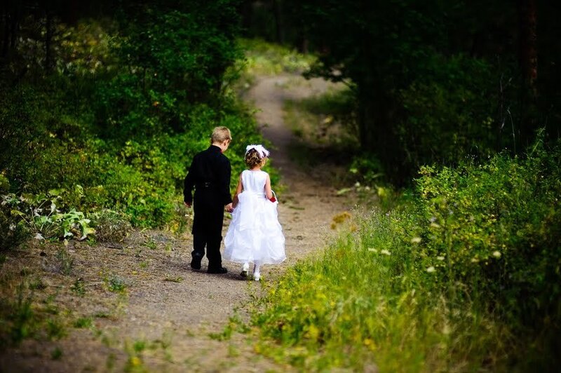 children walking on a forest path