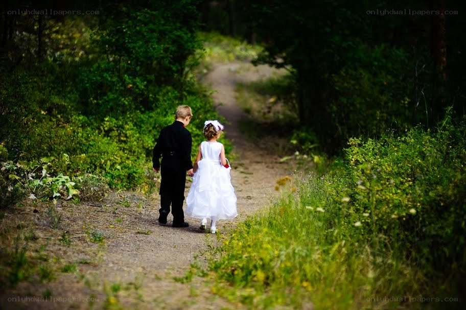 children walking on a forest path