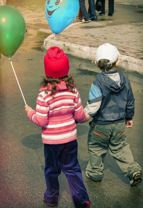 Children walking with balloons