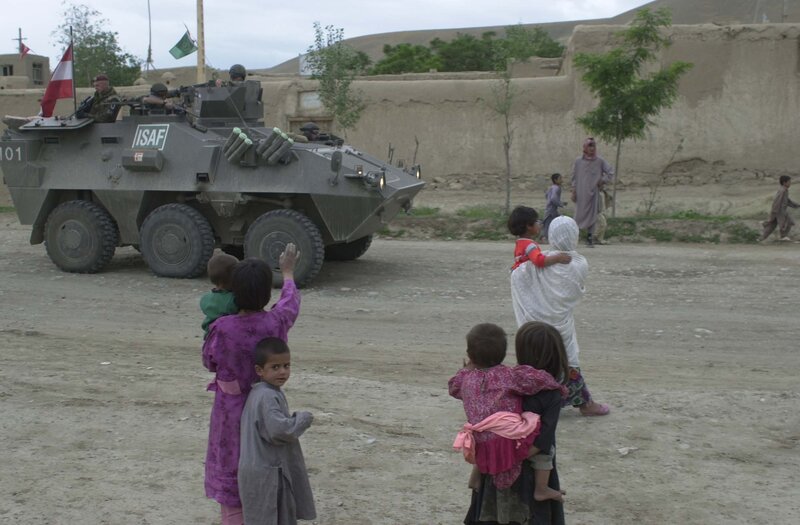 Children watch military vehicle
