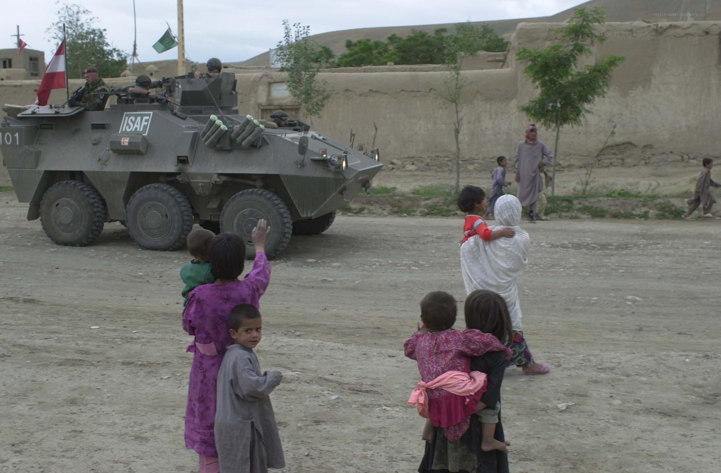 Children watch military vehicle