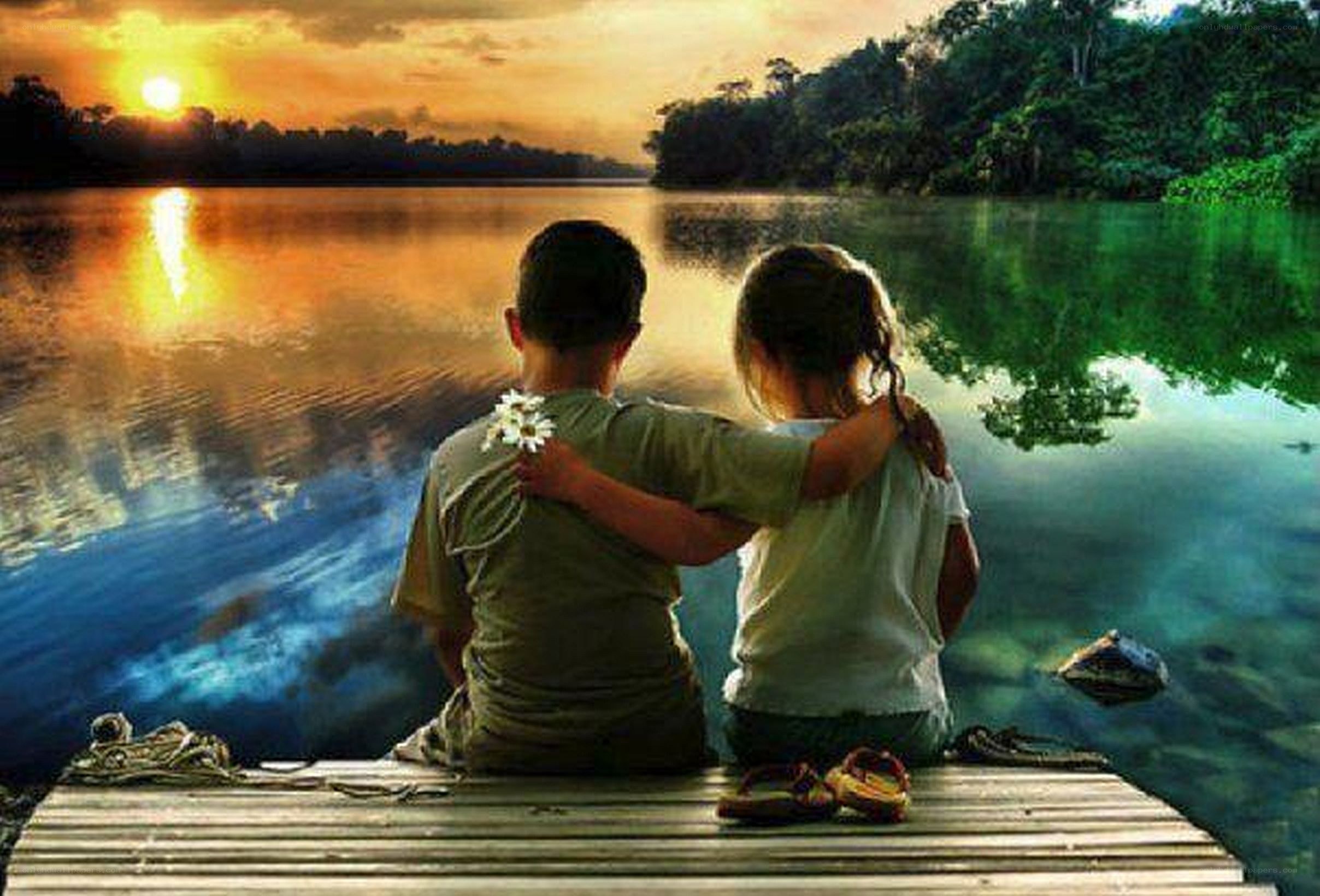 Children watching sunset by the lake