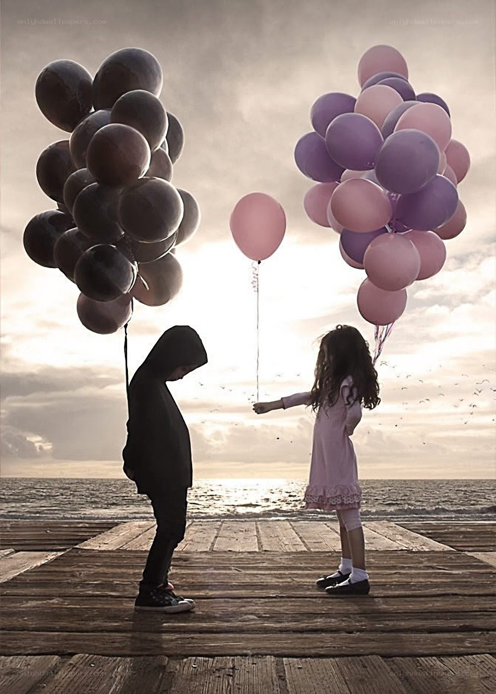 Children with balloons on pier