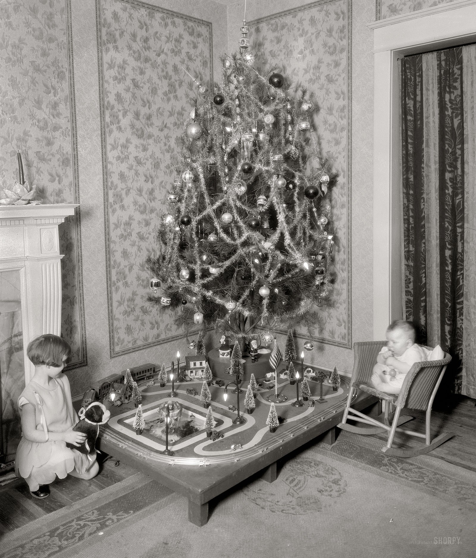 Children with Christmas tree and train set