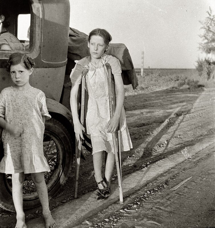Children with crutches on a road