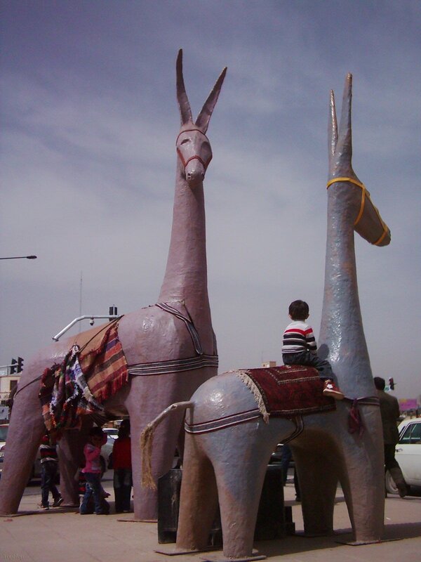 Children with large donkey sculptures