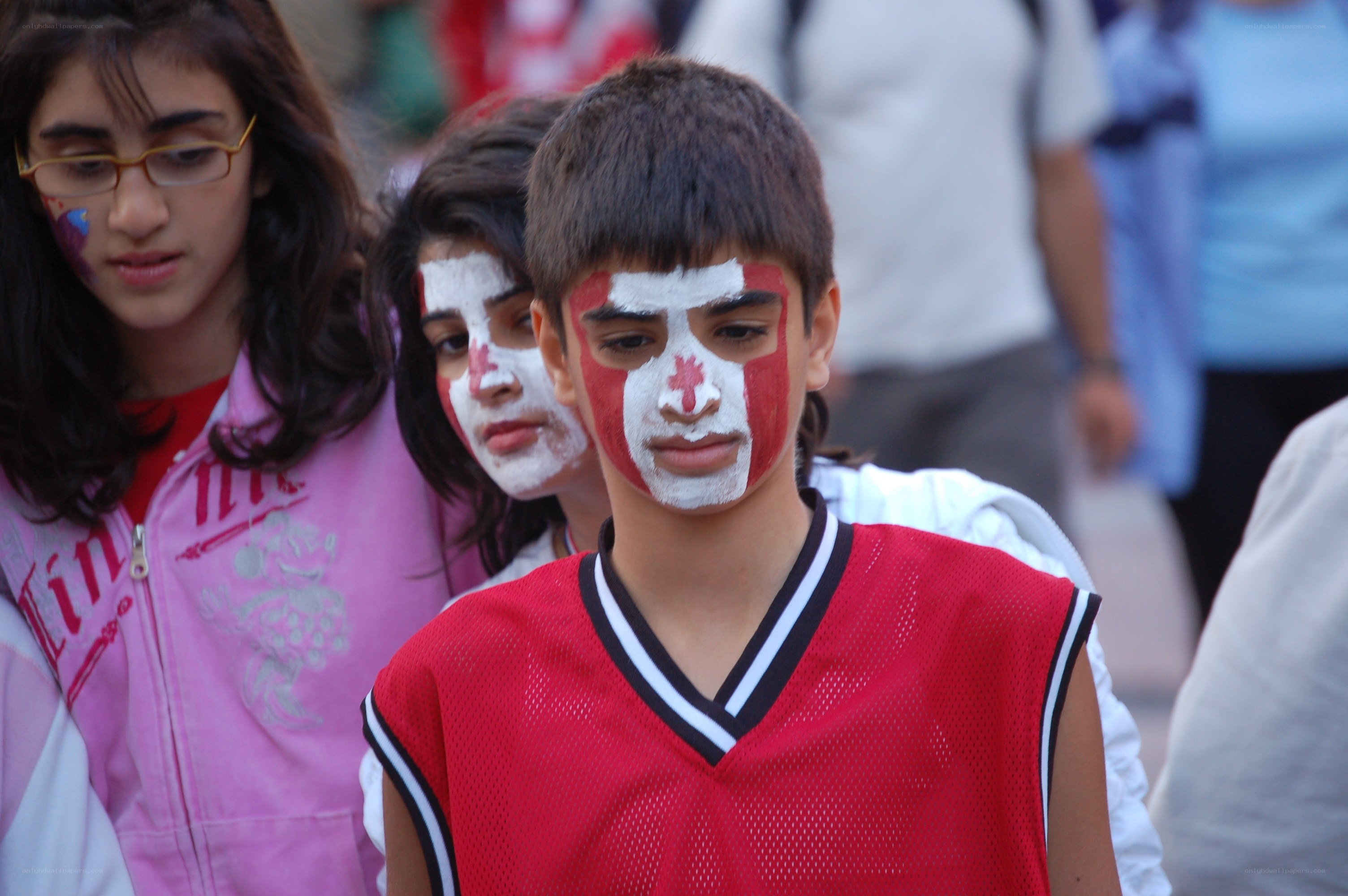 Children with painted faces at event