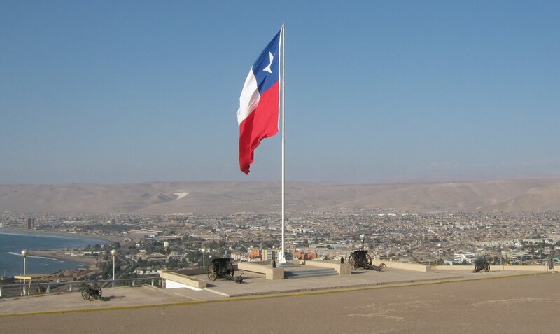 Chilean flag over coastal city