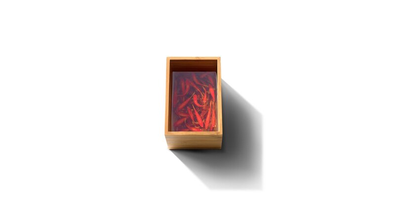 chili peppers in a wooden box