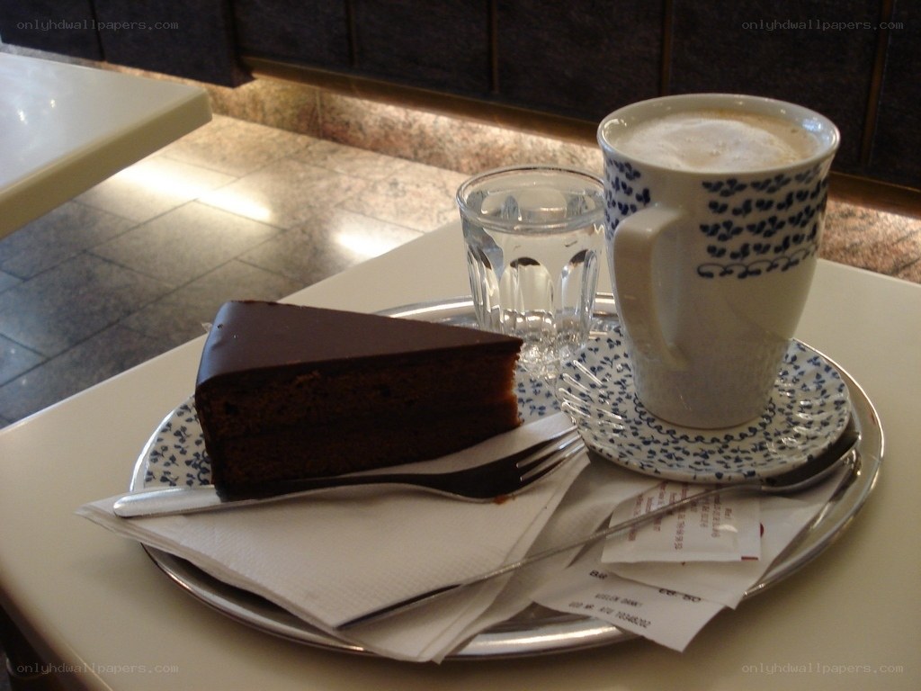 Chocolate cake and coffee on a tray