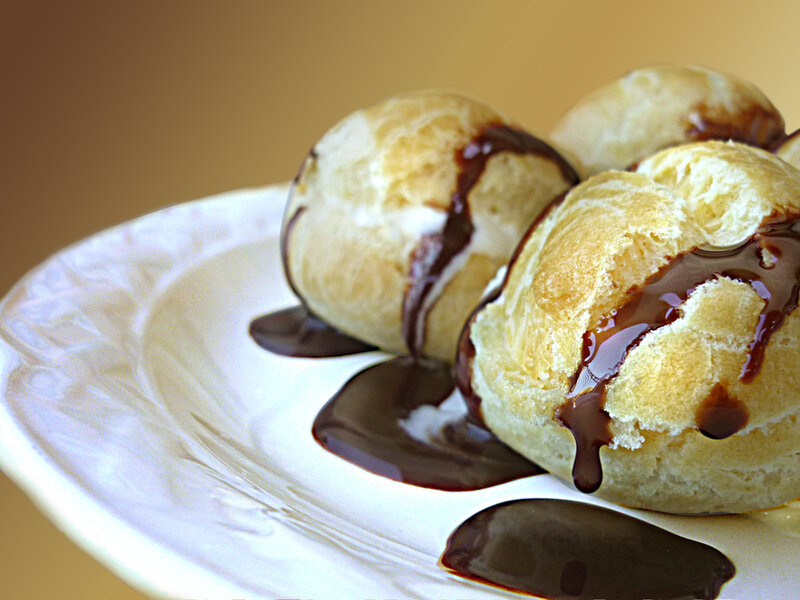 Chocolate-drizzled cream puffs