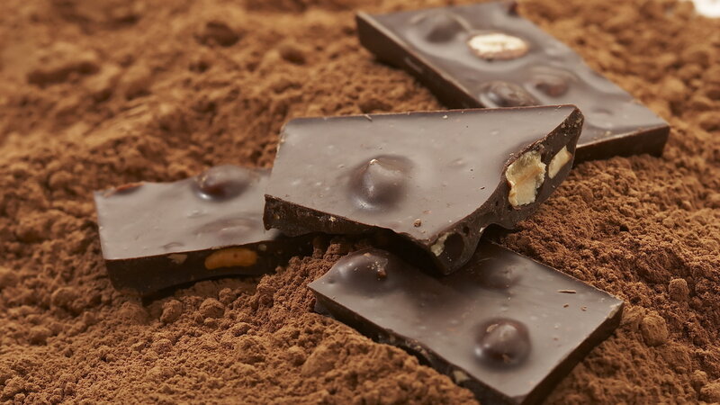 Chocolate Pieces on Cocoa Powder — Brown, Rich