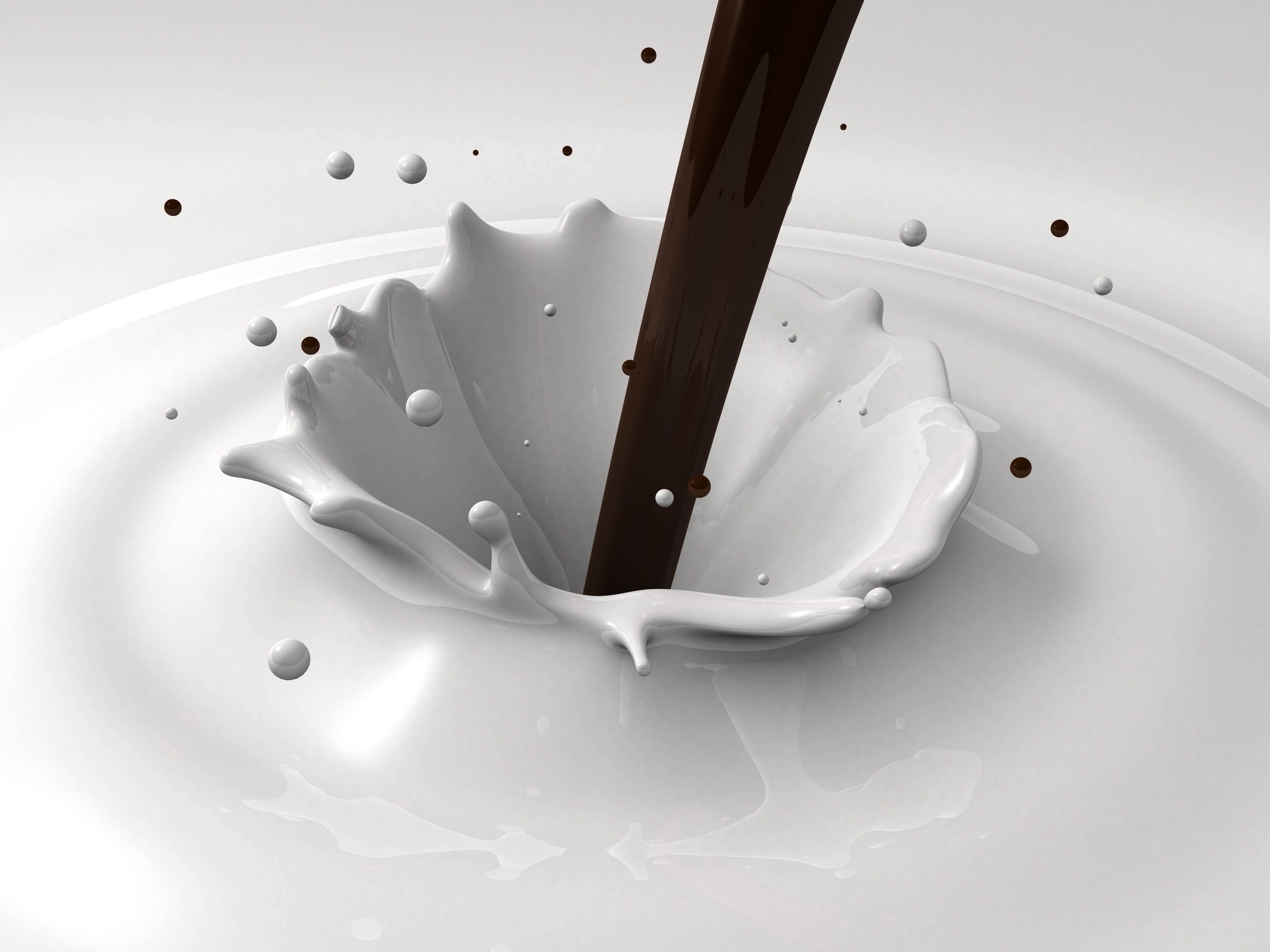 Chocolate pouring into milk