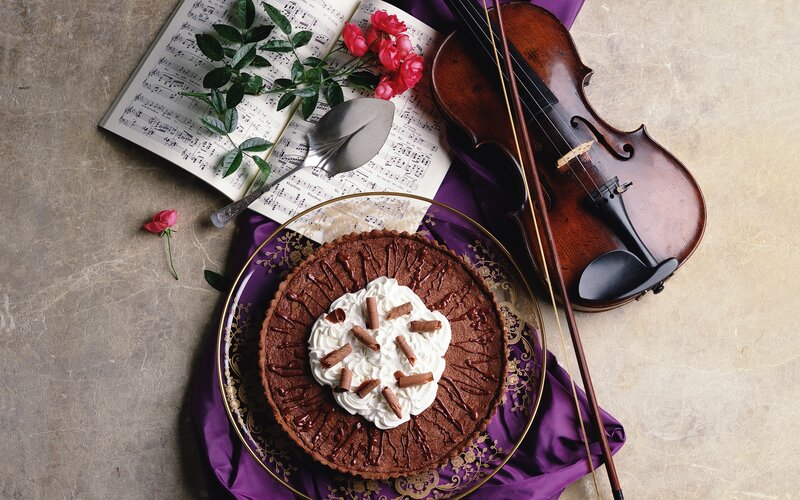 Chocolate tart with violin and sheet music