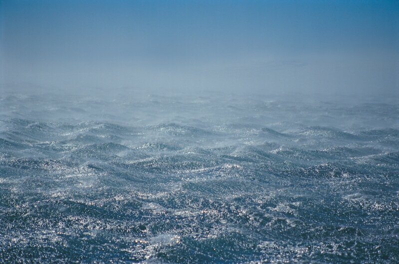 Choppy ocean waves under blue sky