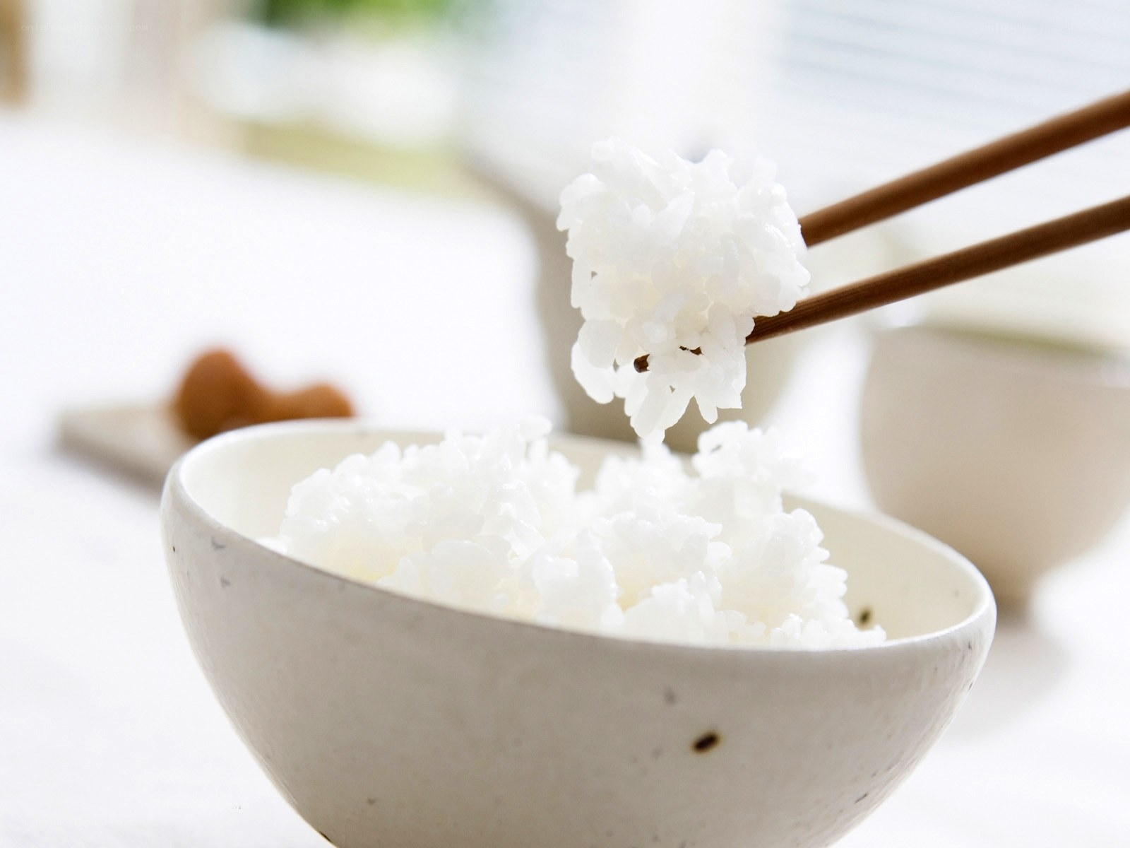 chopsticks holding rice
