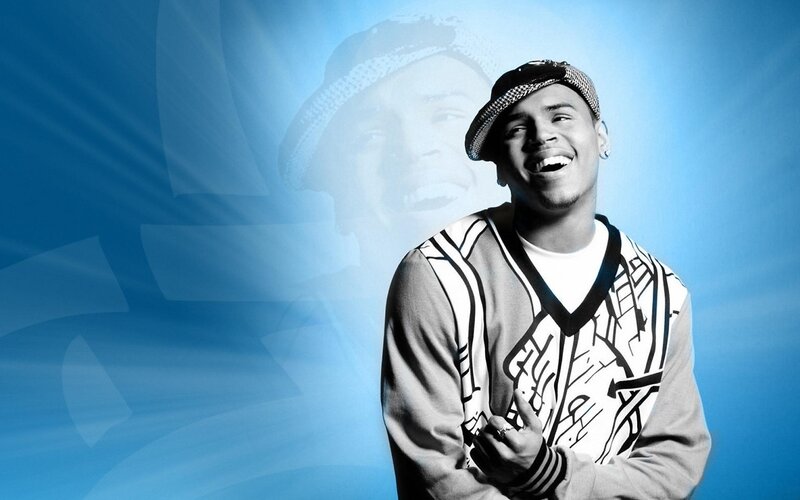 Chris Brown smiling in a cap