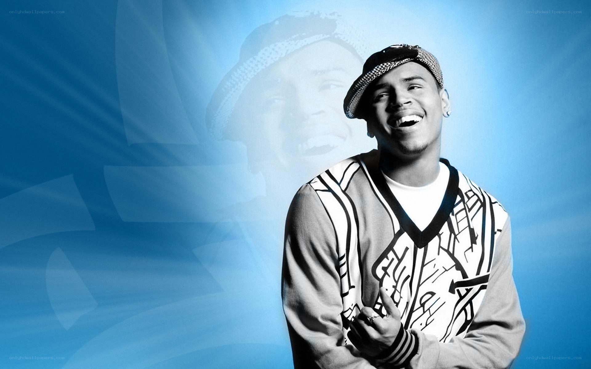 Chris Brown smiling in a cap