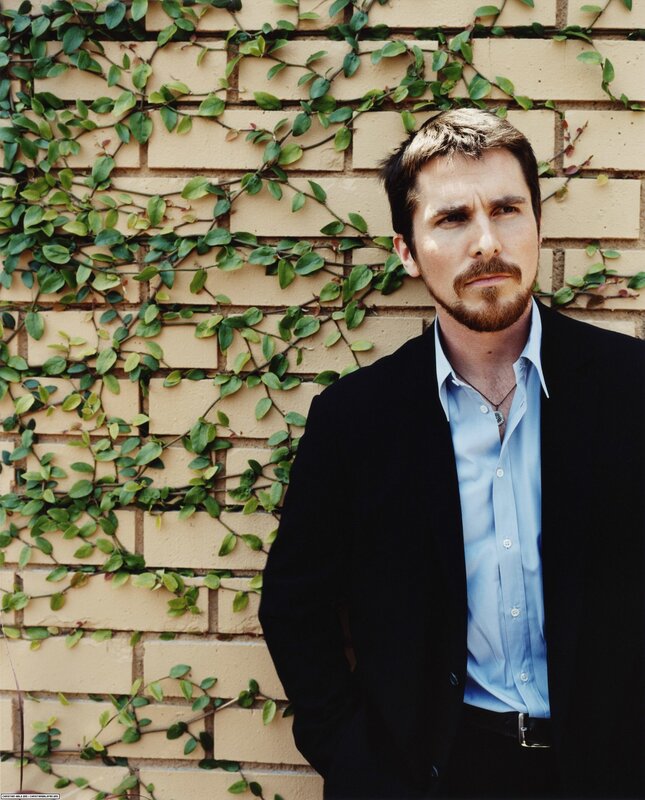 Christian Bale in front of ivy wall