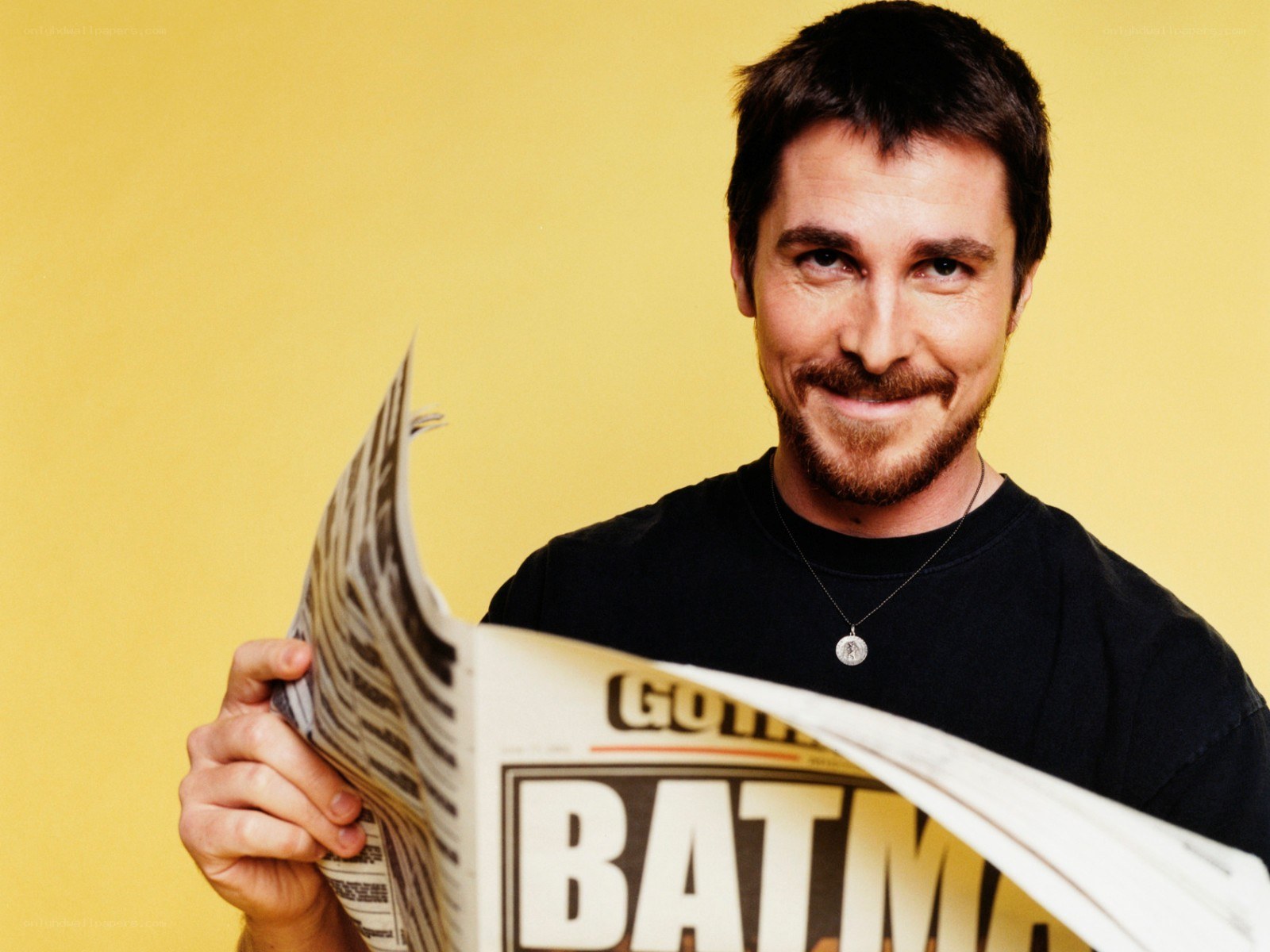 Christian Bale reading newspaper
