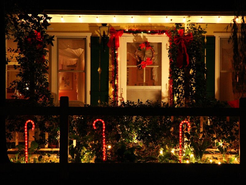 Christmas-decorated porch at night