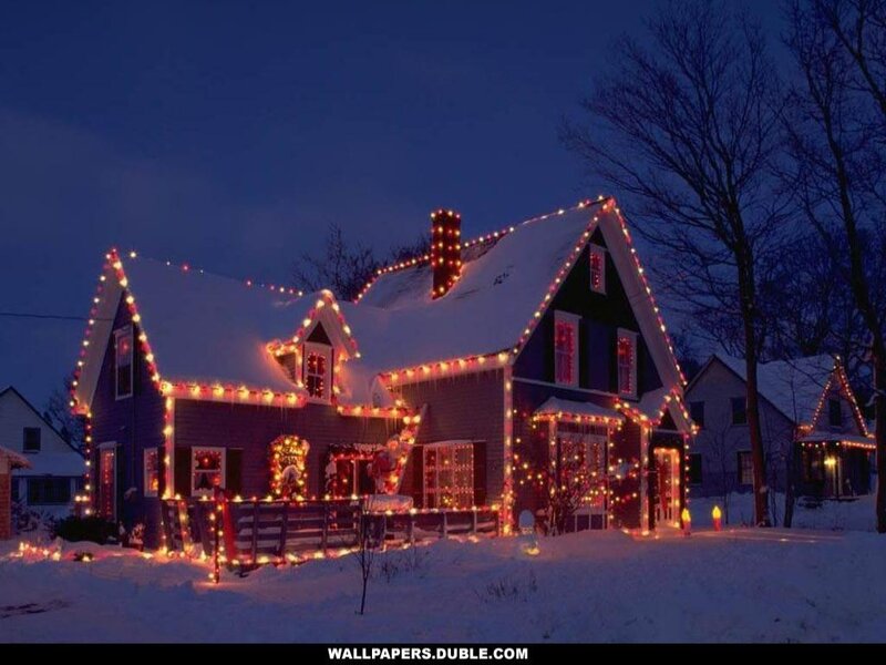 Christmas lights on a snowy house