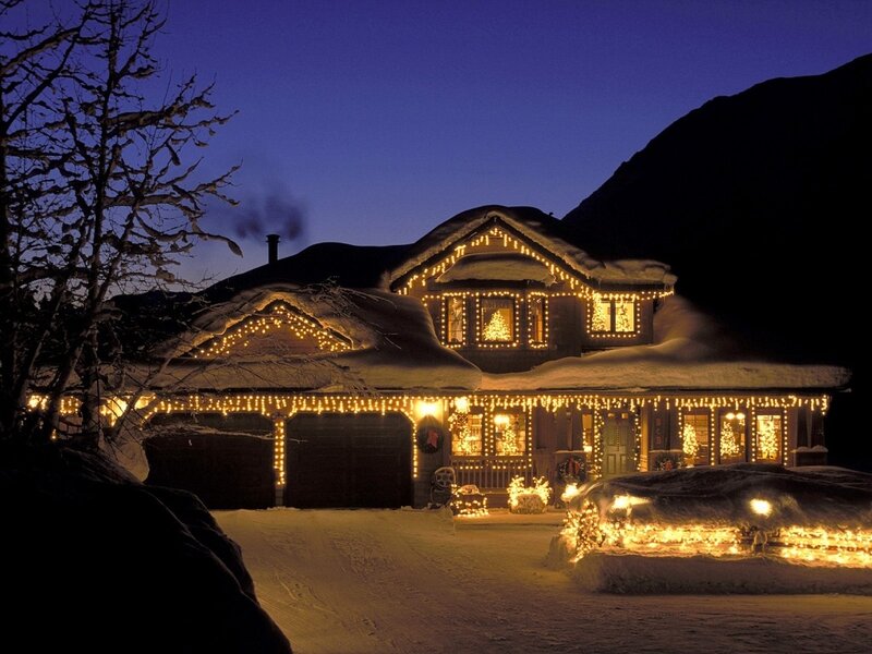 Christmas lights on a snowy house