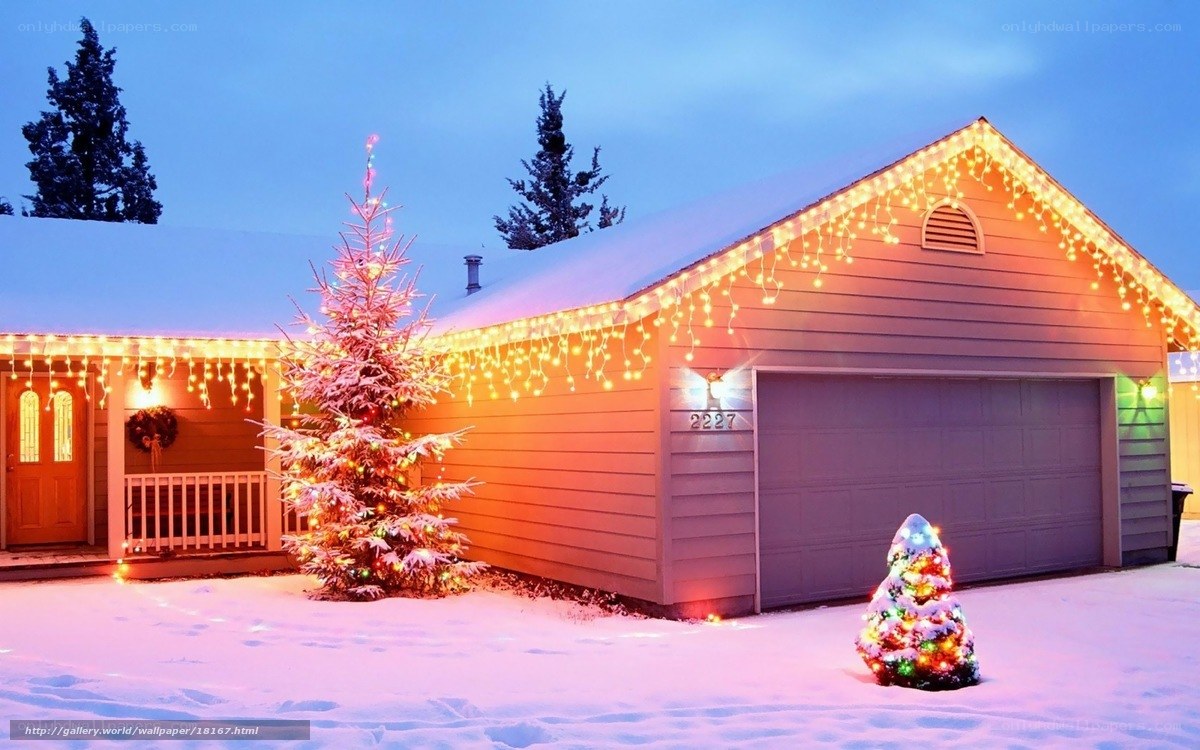 Christmas lights on a snowy house