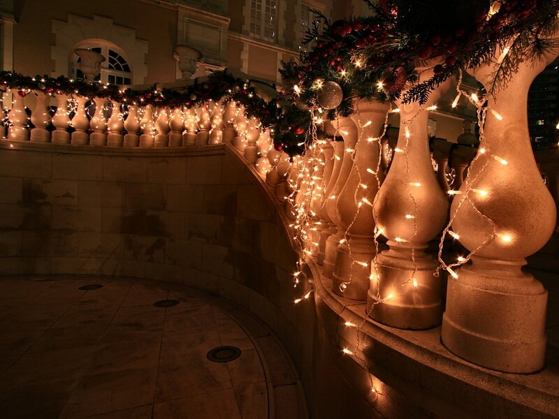 Christmas lights on a stone balcony