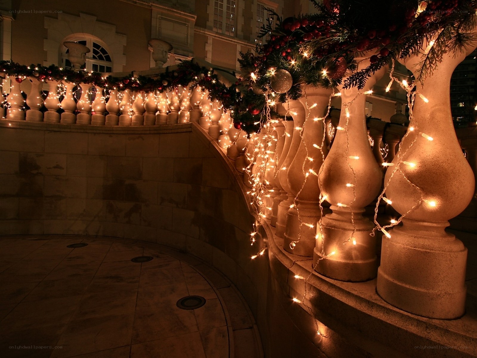 Christmas lights on a stone balcony