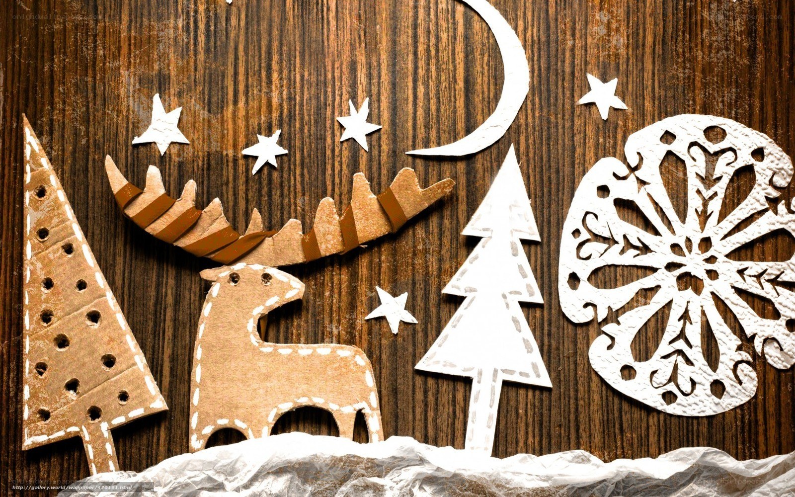Christmas paper cutouts on wood