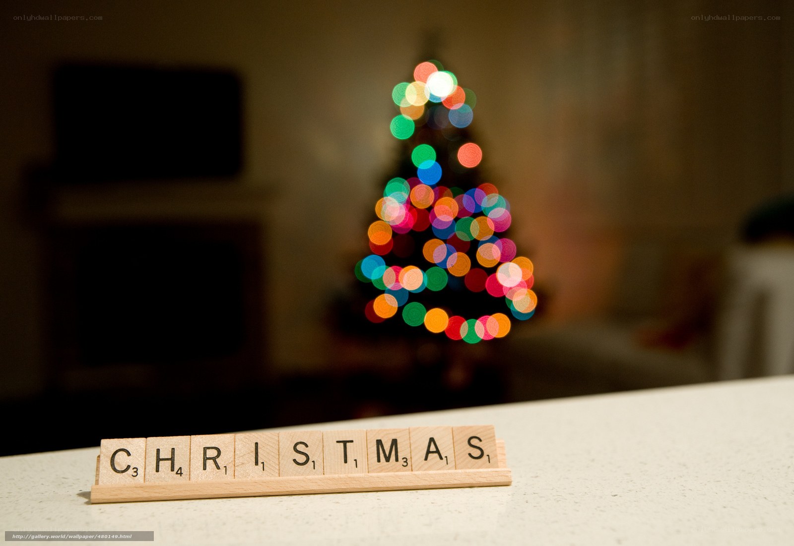 Christmas scrabble tiles with blurred lights