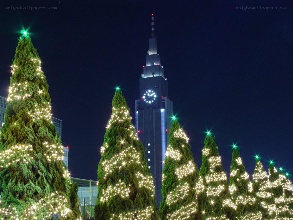 Christmas trees and clock tower at night