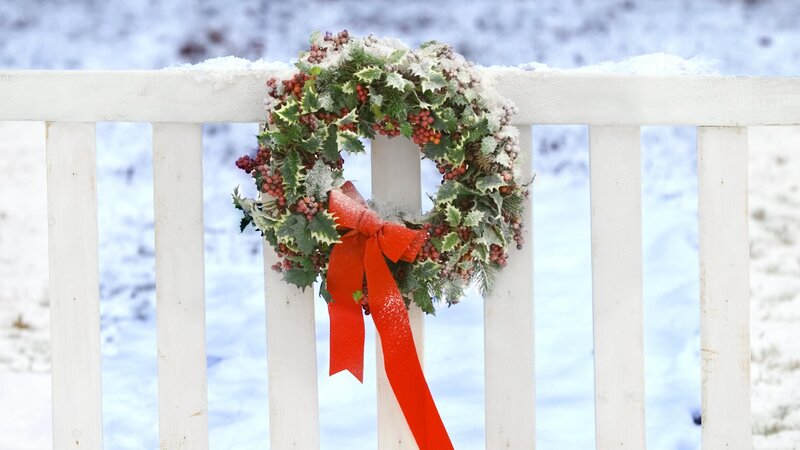 Christmas wreath on snowy fence