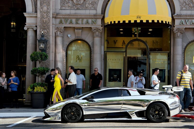 Chrome car outside luxury store