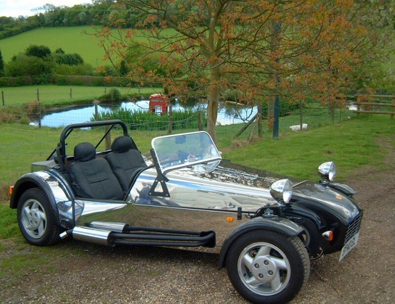 Chrome sports car by a pond