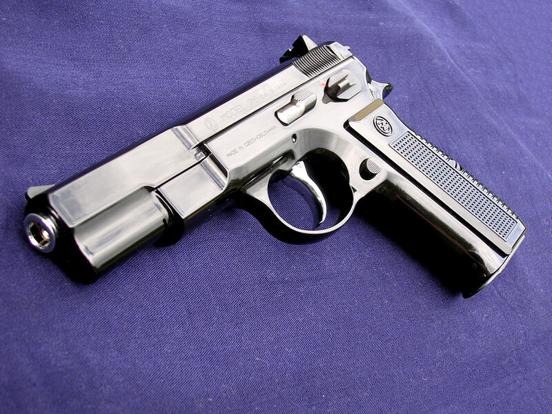 Chromed pistol on purple cloth