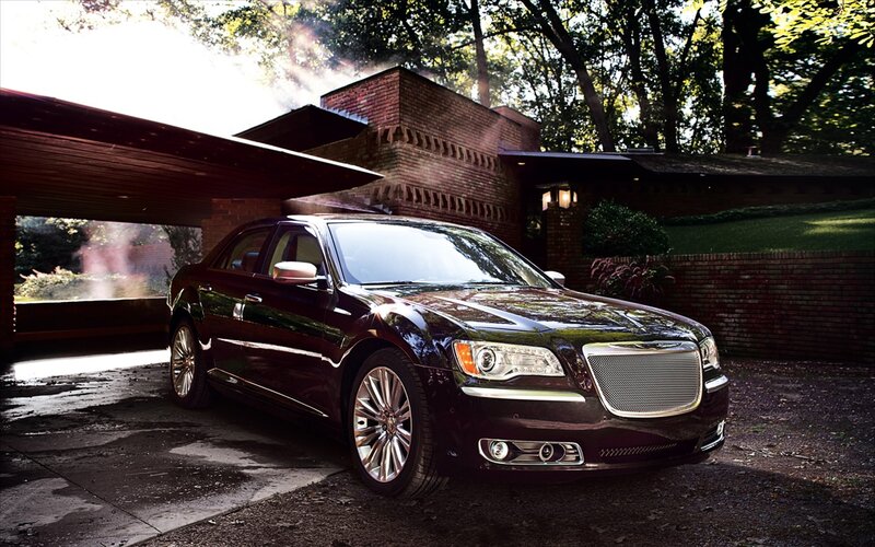 Chrysler 300 in front of brick house