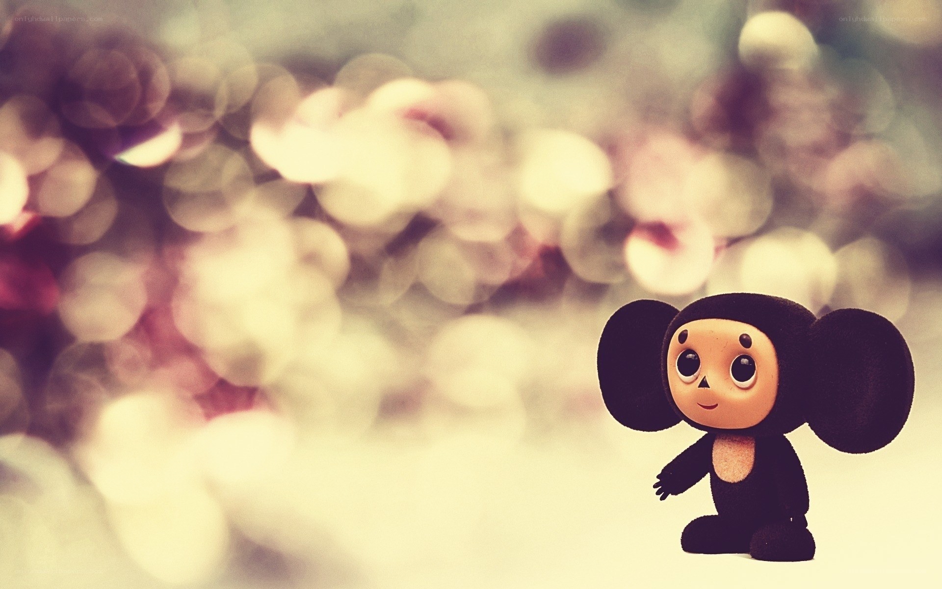 Chubby monkey toy in bokeh
