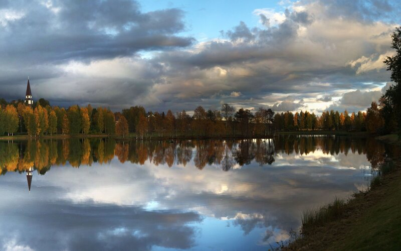 Church and autumn trees reflected in lake